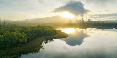 a body of water with trees and a factory in the background - Carbon Capture, Sequestration, and Utilization Law