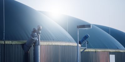 a large round metal structures with a blue cover - Biogas and Renewable Natural Gas Law